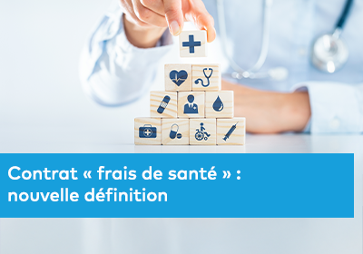 Une main positionne un cube en bois avec un symbole médical au sommet d’une pyramide représentant différents services de santé.